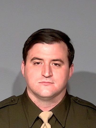 Portrait of a man in a uniform with a neutral expression.