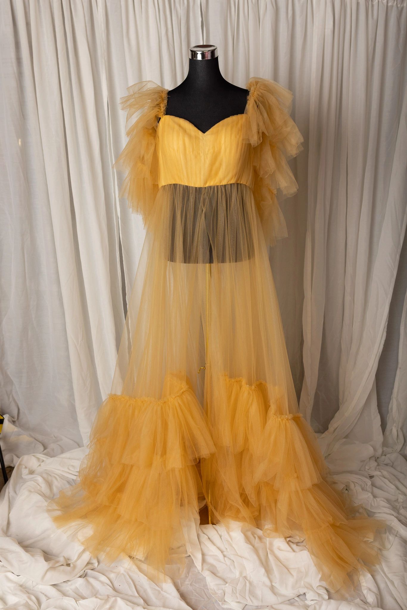 Elegant yellow tulle dress on a mannequin.