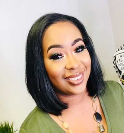 Smiling woman with straight black hair and makeup.