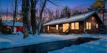 Nestled on a private 2.9-acre wooded lot in Richmond, Maine, this charming 1980's log home offers pe