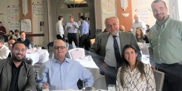 Business professional posing with a small group