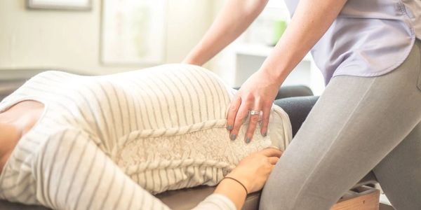 Prenatal woman getting a Webster treatment