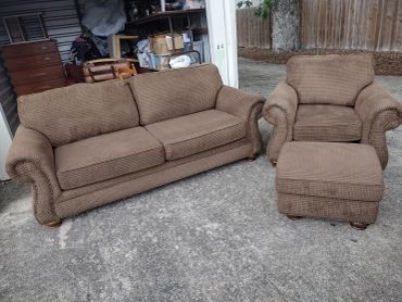 Brown sofa set with couch, armchair, and ottoman outdoors.