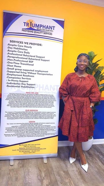 Woman in red dress standing next to a service banner.
