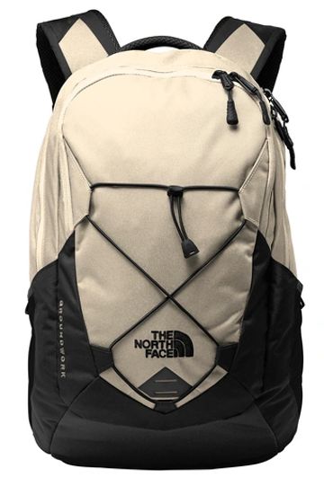 Beige and black North Face backpack with front bungee cords.