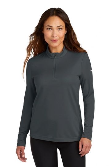 Woman wearing a dark gray long-sleeve quarter-zip top and black pants.