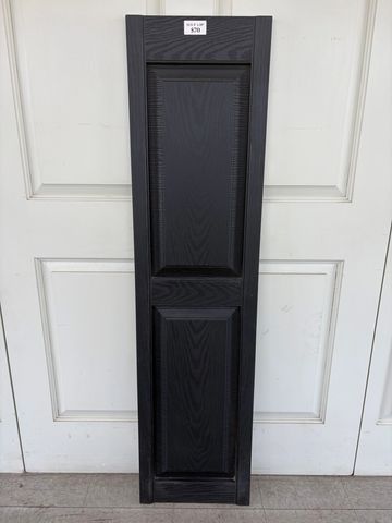 Tall black cabinet door panel with wood grain texture.