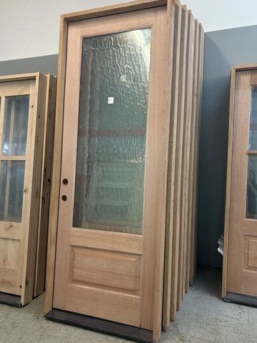 Wooden doors with glass panels standing upright.