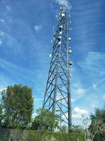 Tall communication tower against blue sky.