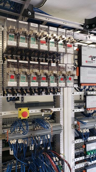 Electrical control panel with wires and labeled components.