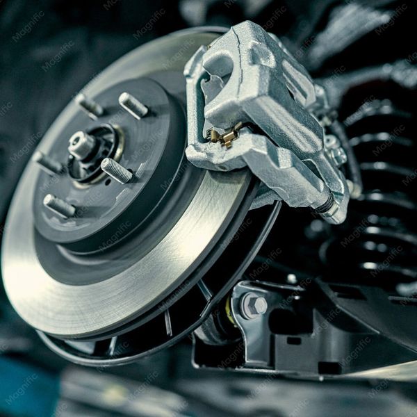 Close-up of a car's disc brake and caliper assembly.