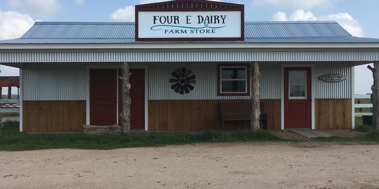 Exterior view of Four E Dairy Farm Store building with metal siding.
