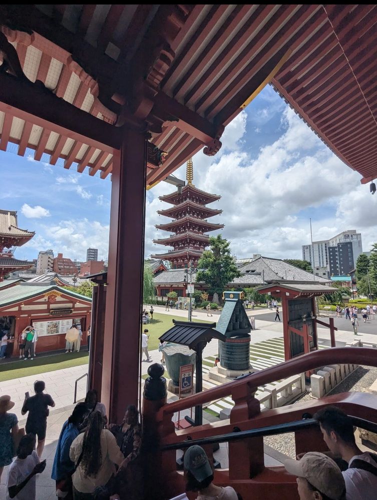 Family exploring a traditional Japanese temple with a five-story pagoda under a bright sky—perfect cultural stop for a Japan family adventure.