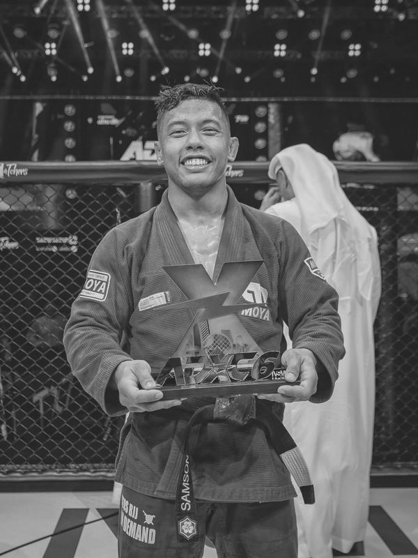 A scenic view of mountains under a clear blue sky, with lush greenery in the foreground.