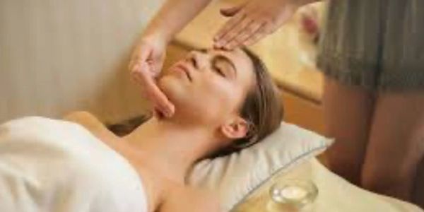 Woman receiving a relaxing facial massage at a spa.