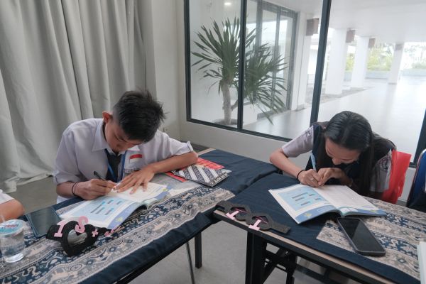 Two students studying diligently at a table.