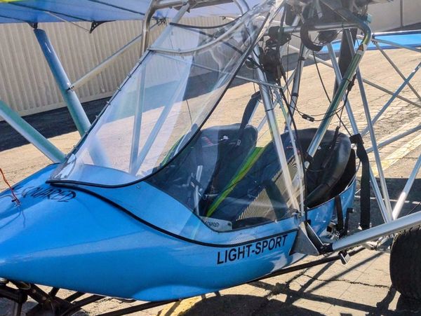 Close-up of a blue light-sport aircraft on the ground.