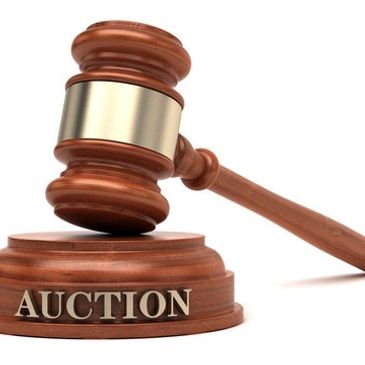 Wooden auction gavel and block with AUCTION text.