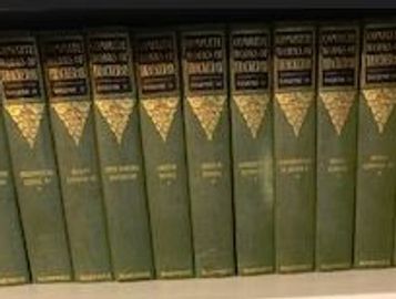 A set of encyclopedias on a shelf.