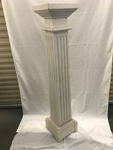 Tall decorative column with fluted design.