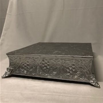 Decorative black embossed box with floral patterns.