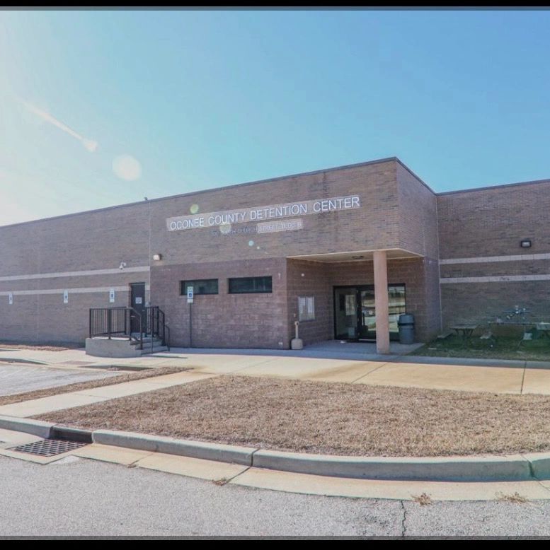 Exterior view of Oconee County Detention Center under a clear blue sky.