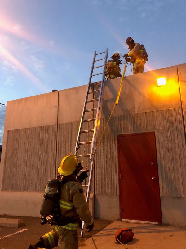 Local Fire Department training with ladders and ropes.