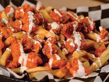 Golden Fried Popcorn Chicken & Fries in Buffalo Sauce Topped With Ranch