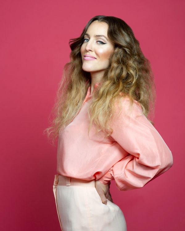 marie-clo in pink outfit over red background