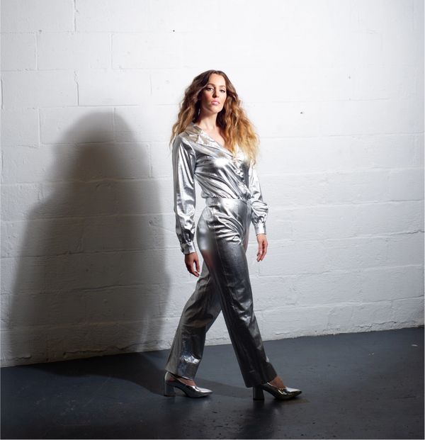 marie-clo outfit in silver over white brick background