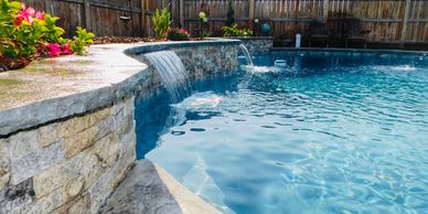 Raise wall with water features makes a beautiful backdrop for your pool. 