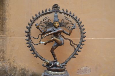 Bronze statue of dancing Shiva Nataraja with multiple arms and intricate details.