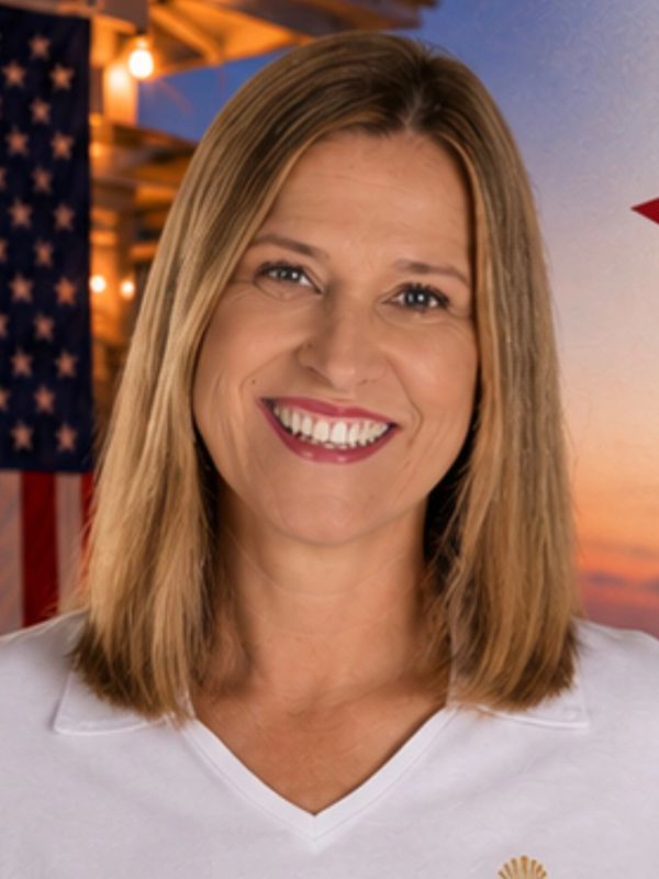 Smiling woman in a Southern Sands Realty shirt.