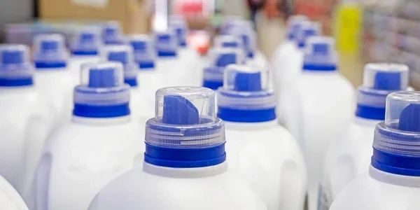 Rows of white plastic bottles with blue caps.
