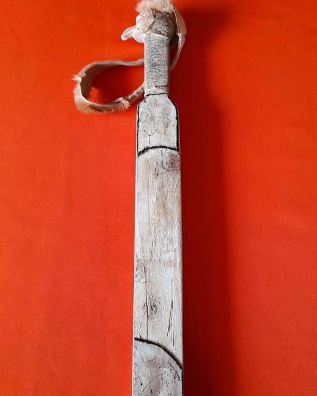 A bone white slapstick / battocchio with a small Pulcinella mask on the but of the handle