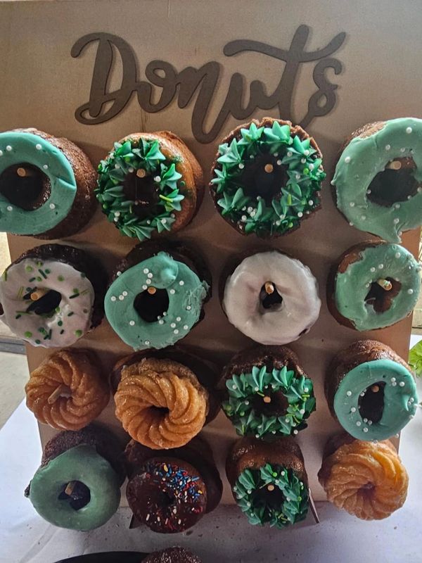 A donut display with various decorated and glazed donuts.