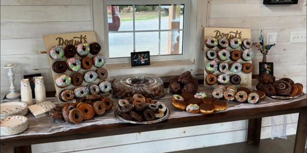 A table filled with various types of donuts and pastries.