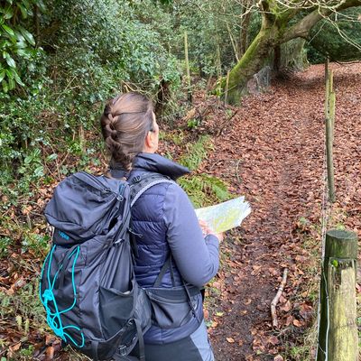Women learning navigation skills with maps and compasses in a Surrey workshop by Joyful Outdoors.