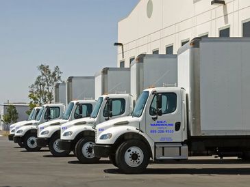 DEF delivery trucks at warehouse