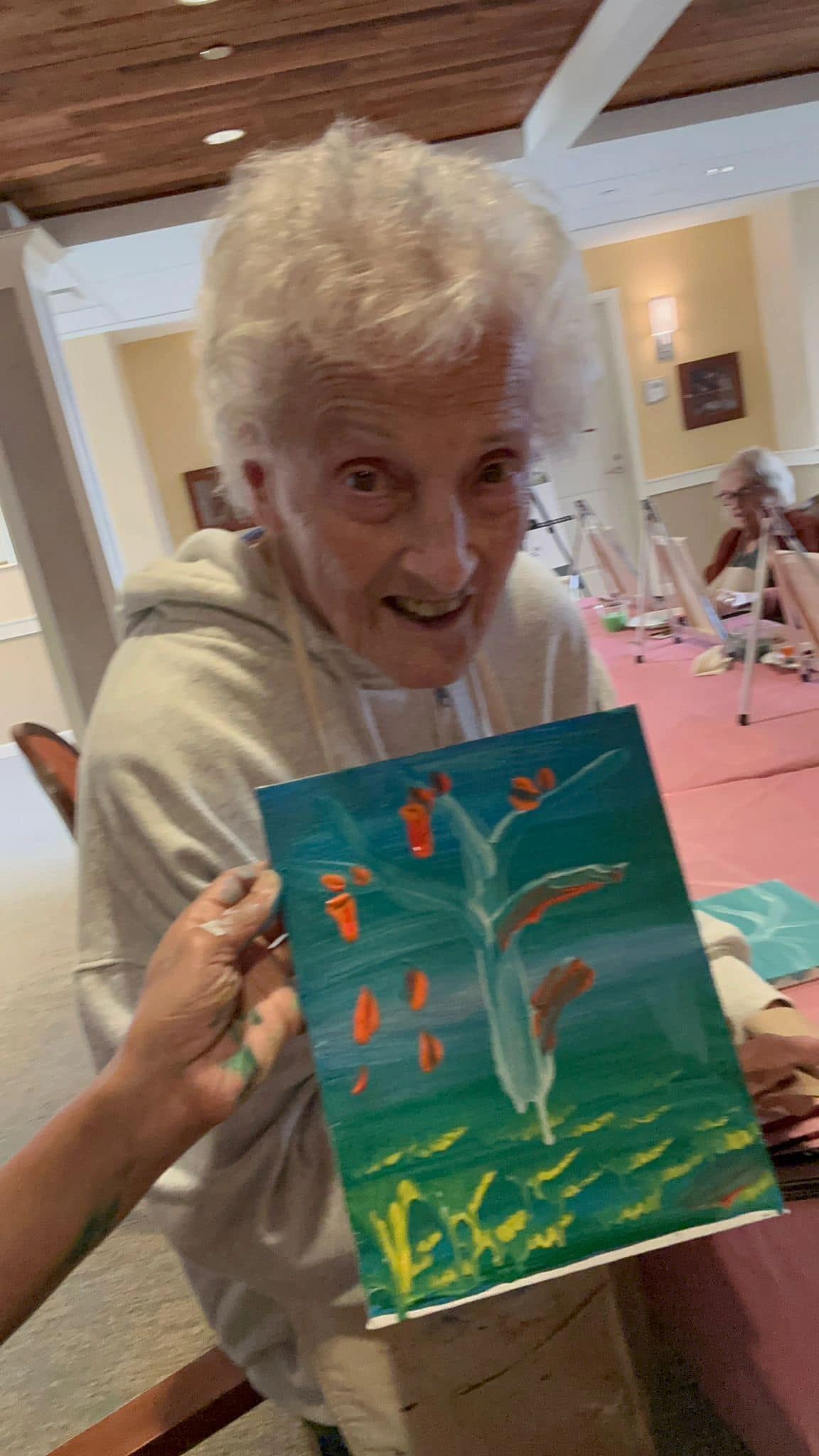 Workshop participant holding artwork.