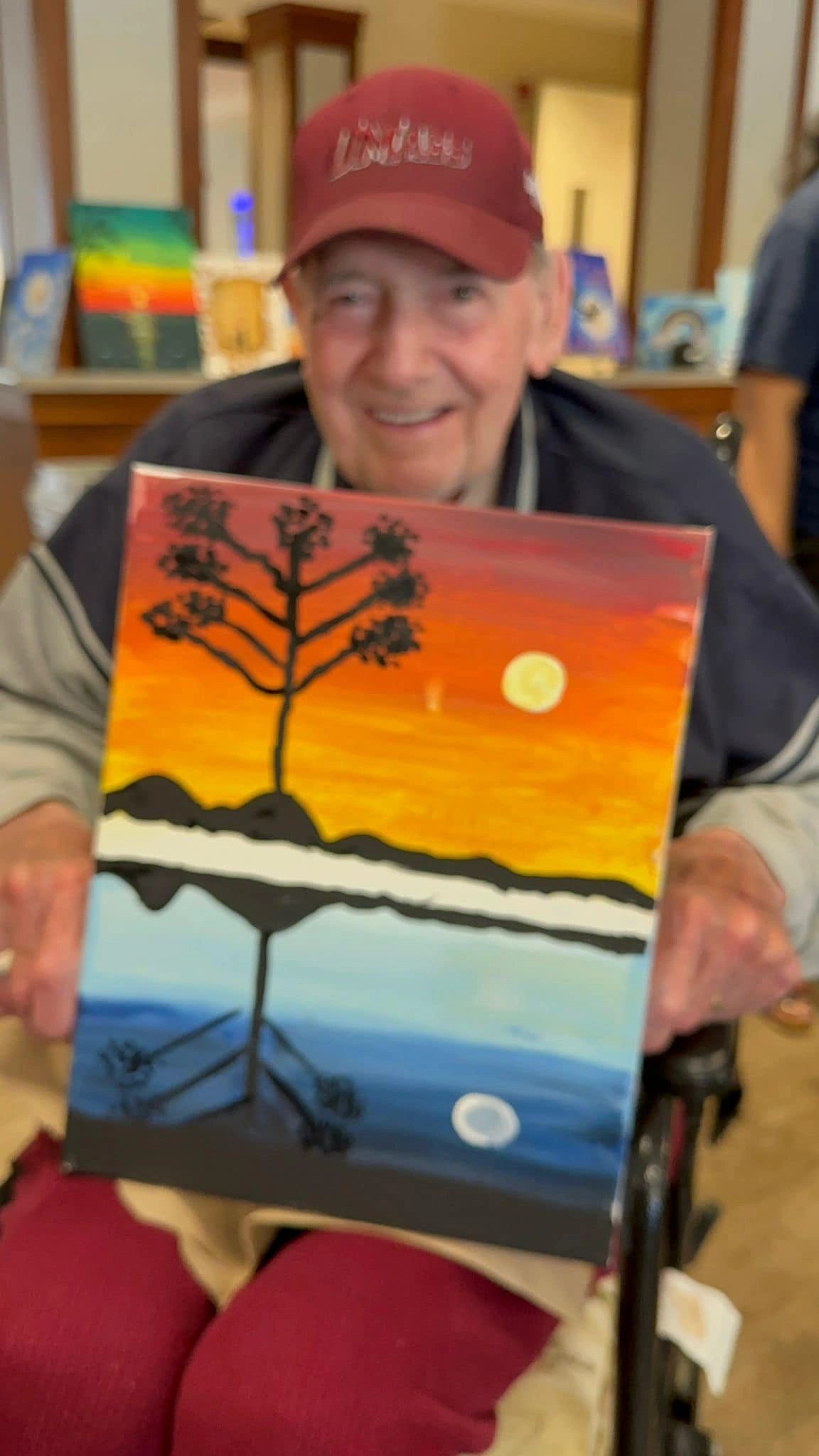 paint workshop participant showing painting.