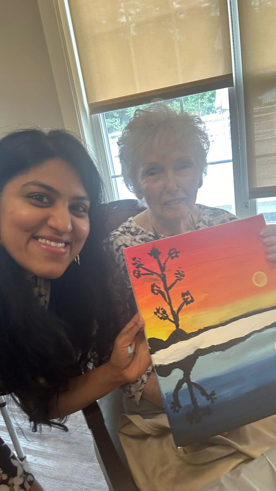 paint workshop participant showing painting.
