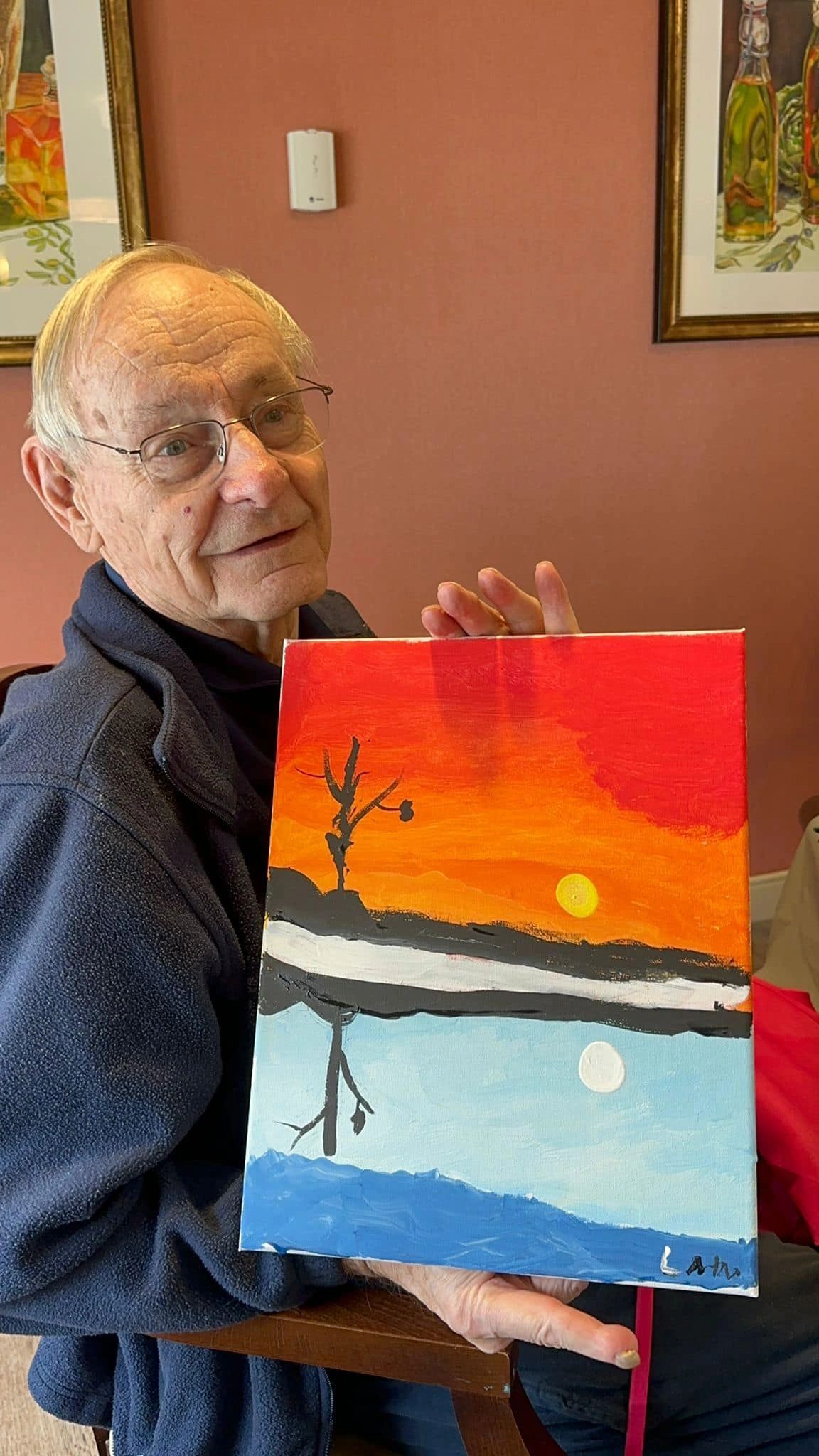 paint workshop participant showing painting.