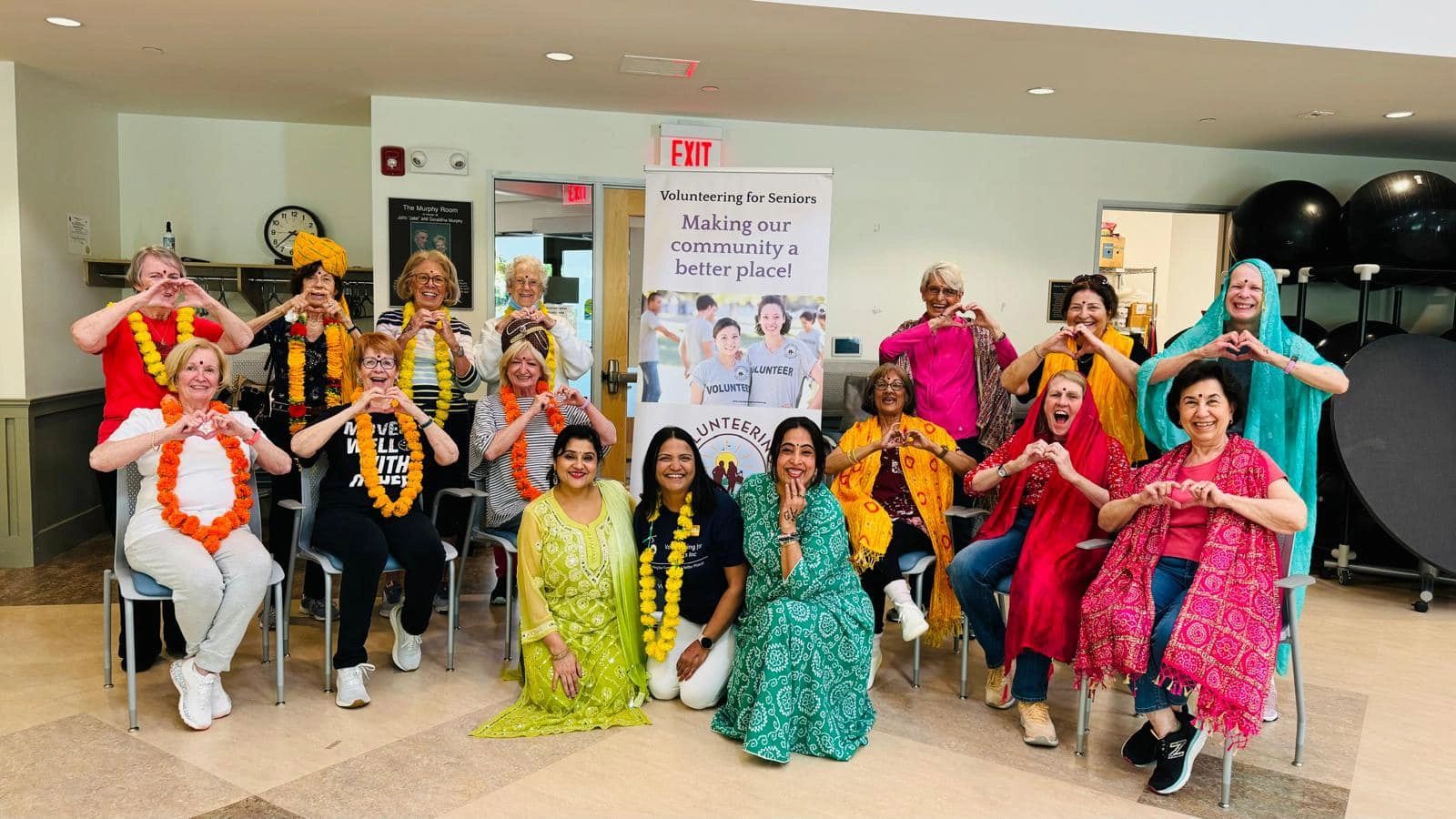 Dancers atthe Walpole Bollywood Dance Workshop in front of VFS banner.
