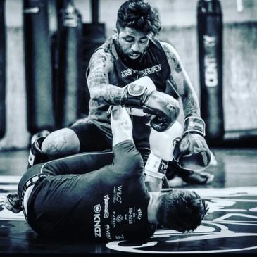 Two men sparring in a boxing and martial arts training session.