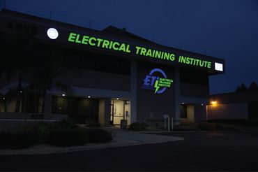 Electrical Training Institute building illuminated at night.