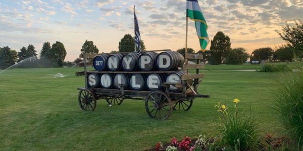 NYPD SMILES barrels in a cart on a field