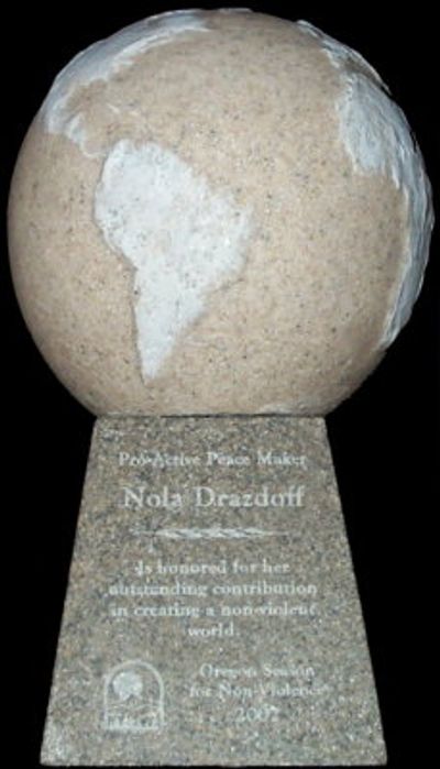Peace maker award with globe and inscription.