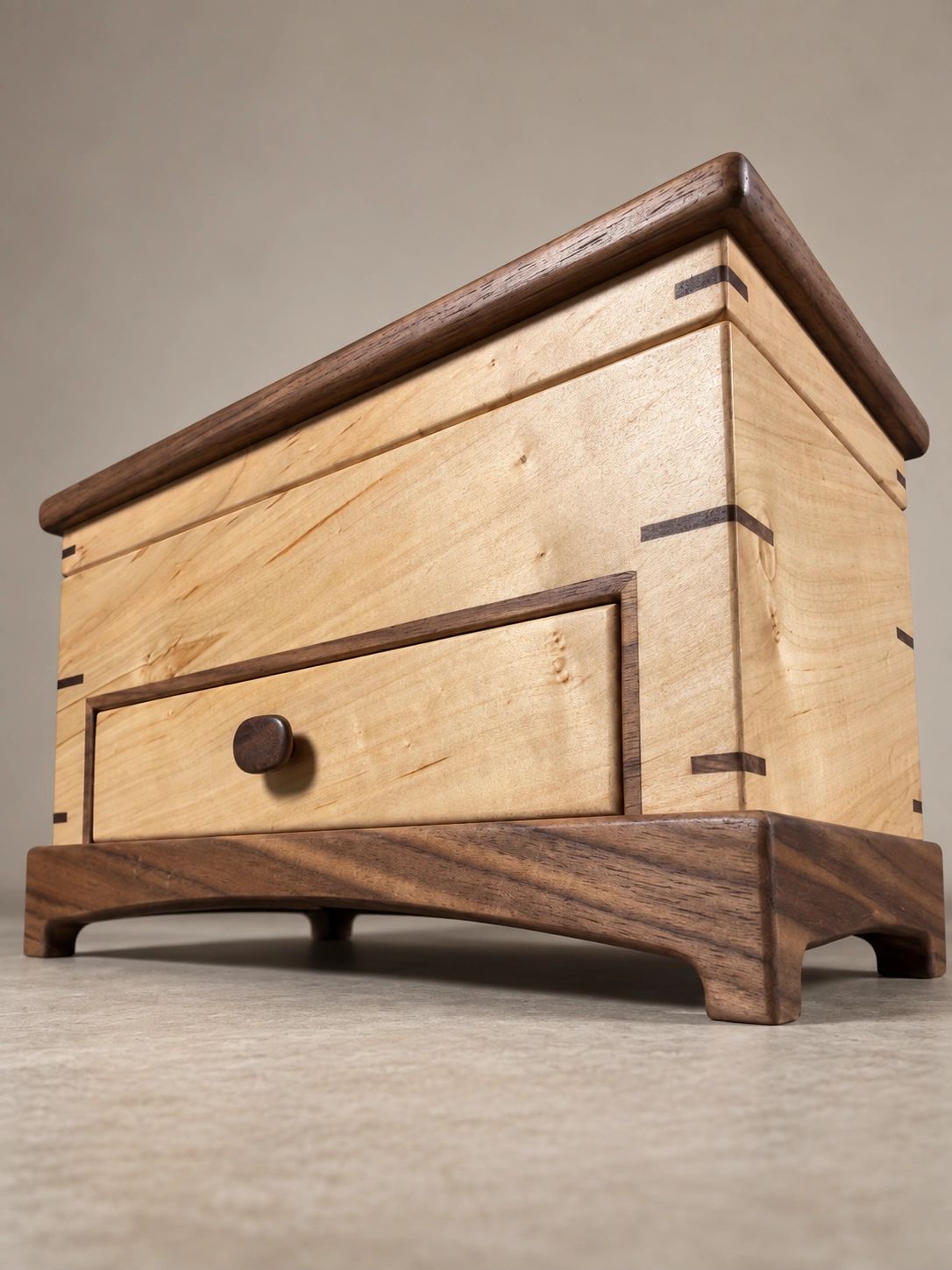 Elegant wooden bedside table with light and dark wood tones.