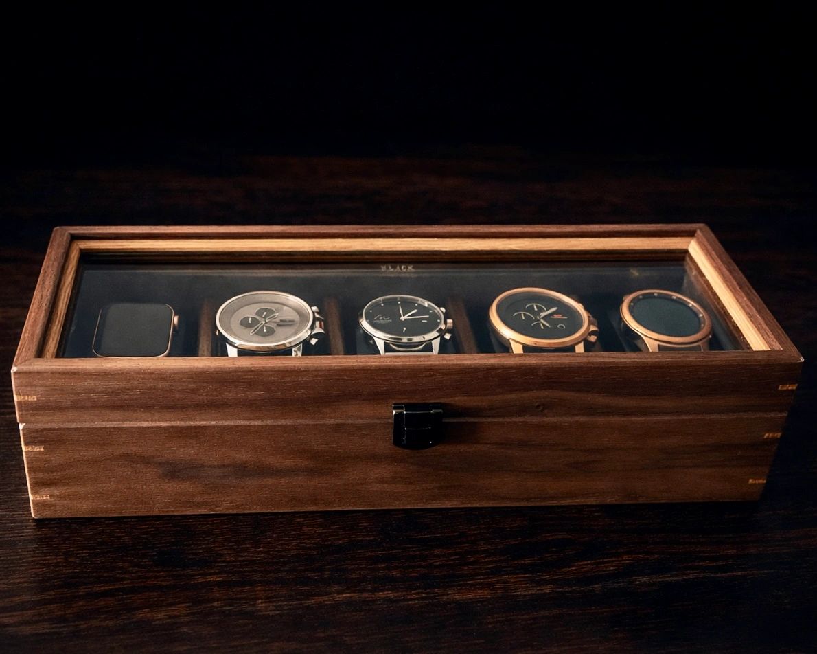 Wooden watch box with five modern watches inside.